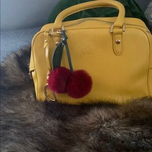 Yellow Designer Handbag with Pom Pom Charm